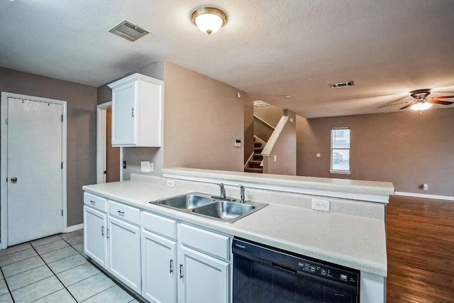 kitchen with ceiling fan, white cabinetry, sink, black dishwasher, and light tile patterned floors