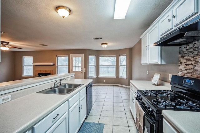 kitchen featuring white cabinetry, sink, tasteful backsplash, light tile patterned floors, and black appliances