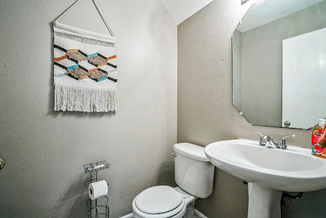 bathroom featuring toilet and sink