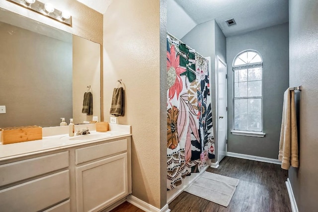 bathroom with a shower with shower curtain, wood-type flooring, and vanity