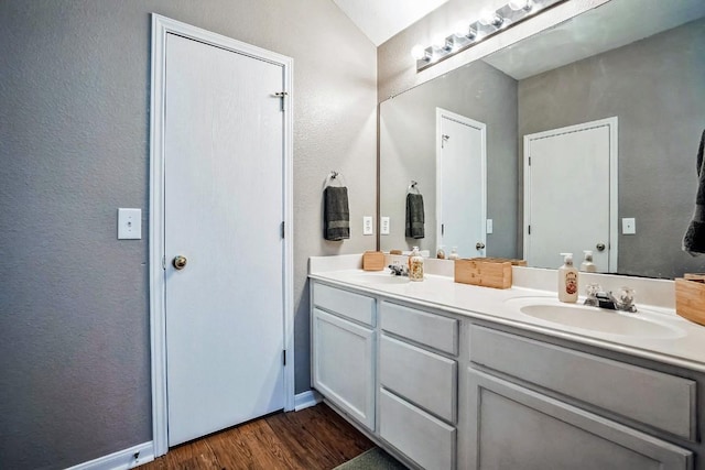 bathroom with hardwood / wood-style floors and vanity