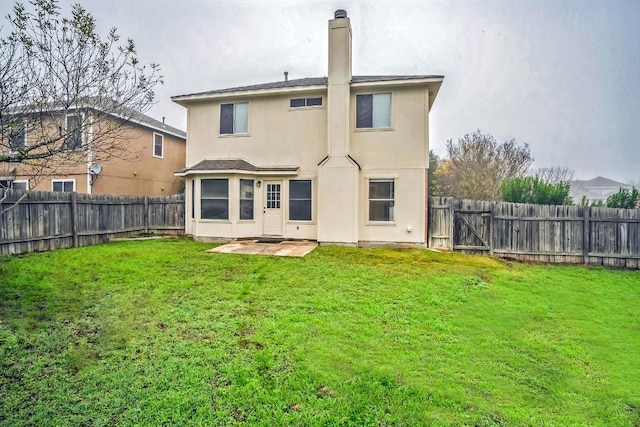 rear view of house featuring a patio area and a lawn