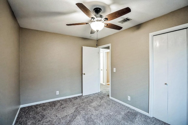 unfurnished bedroom featuring carpet, a closet, and ceiling fan