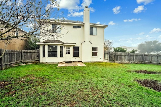 back of property featuring a yard and a patio