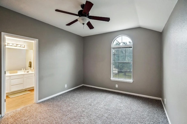 carpeted empty room featuring ceiling fan and lofted ceiling