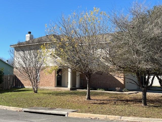 view of front of home featuring a front yard and a garage