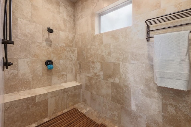 bathroom with tiled shower