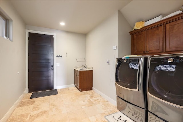 washroom featuring recessed lighting, cabinet space, a sink, separate washer and dryer, and baseboards