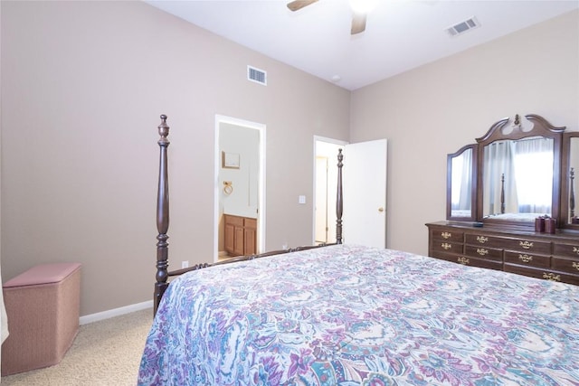 bedroom featuring light carpet, ensuite bathroom, and ceiling fan