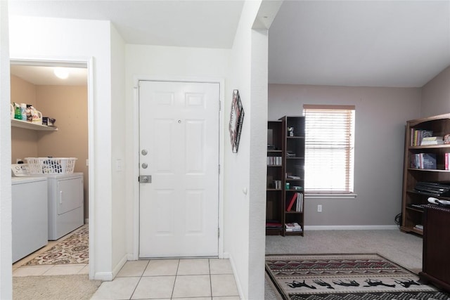 laundry area featuring light tile patterned floors and separate washer and dryer