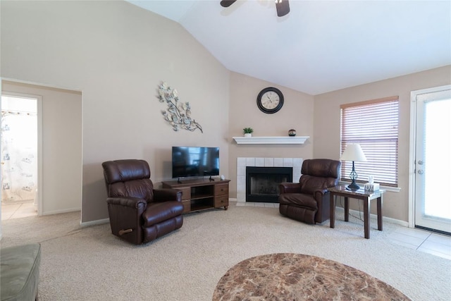 carpeted living room with a fireplace, ceiling fan, and lofted ceiling