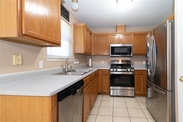 kitchen featuring sink, light tile patterned floors, and stainless steel appliances