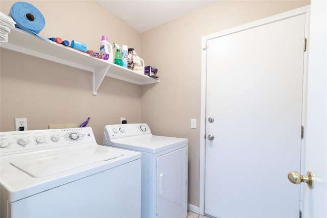 clothes washing area featuring separate washer and dryer