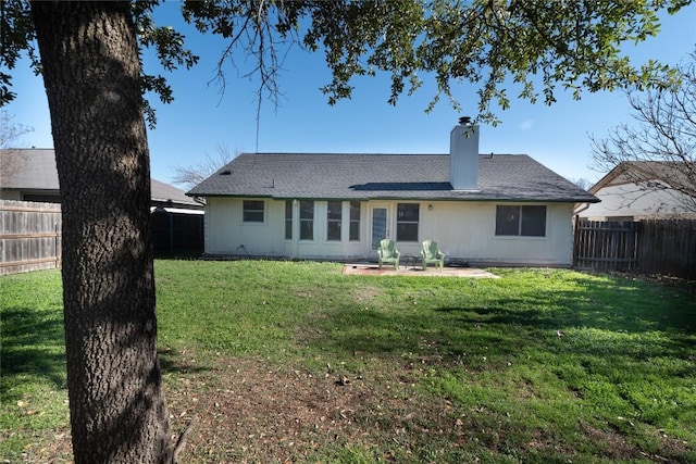 back of property featuring a lawn