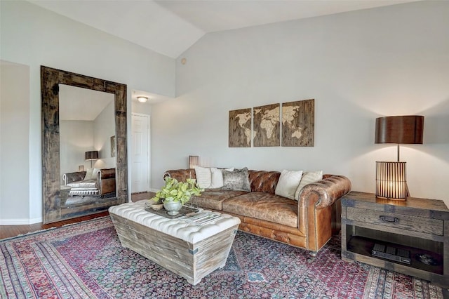 living room featuring hardwood / wood-style flooring and vaulted ceiling