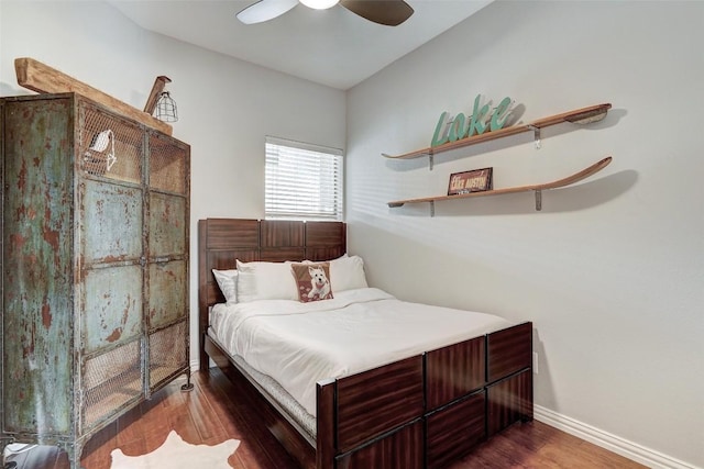 bedroom with ceiling fan and dark hardwood / wood-style flooring