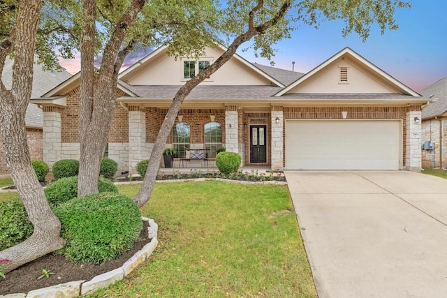 view of front of property with a lawn and a garage