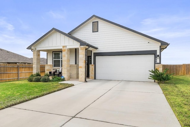 view of front of home with a garage and a front lawn