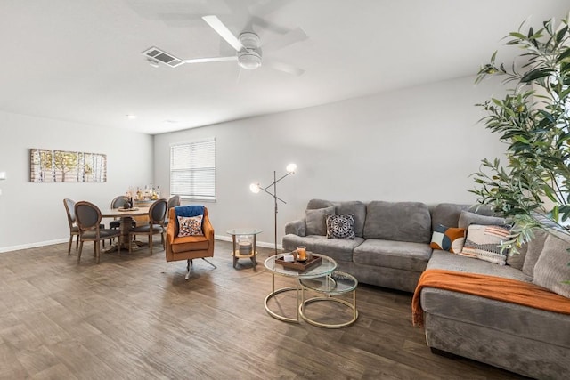 living room with ceiling fan and dark hardwood / wood-style flooring