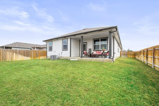 rear view of property featuring a yard and a patio