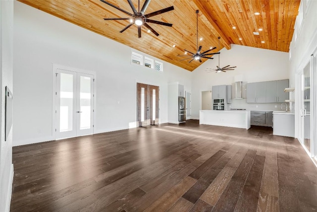 unfurnished living room with wooden ceiling, a high ceiling, french doors, dark hardwood / wood-style floors, and beamed ceiling