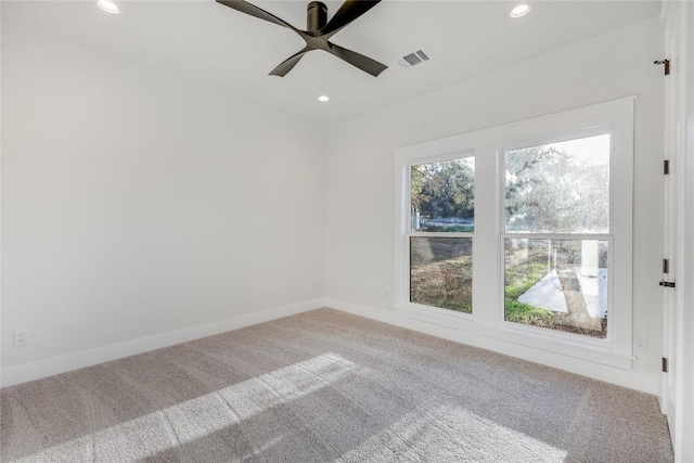 carpeted empty room featuring ceiling fan