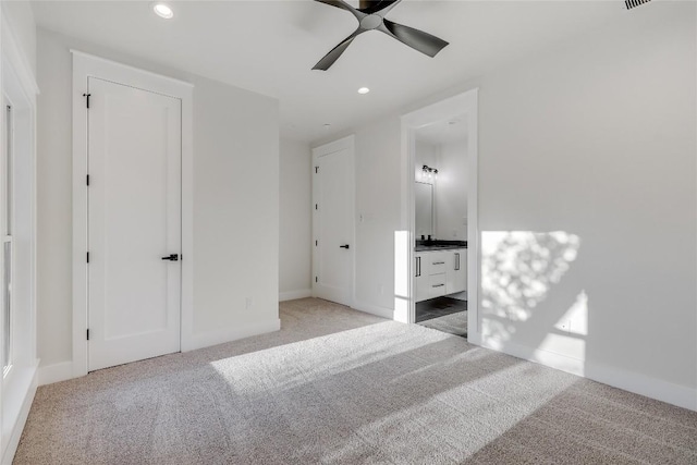 unfurnished bedroom with carpet, ensuite bath, and ceiling fan