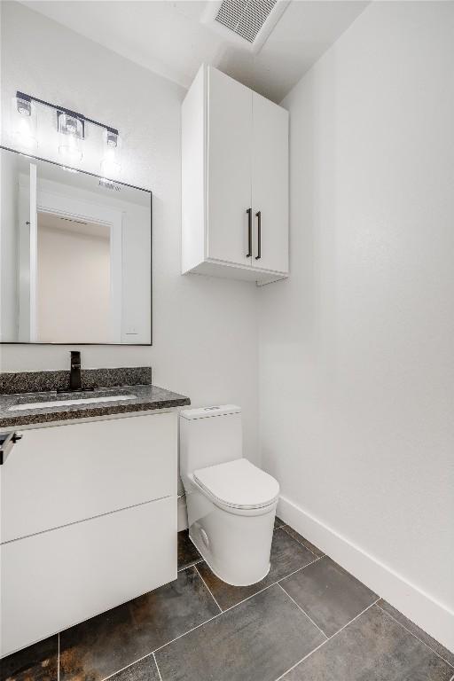 bathroom featuring vanity and toilet