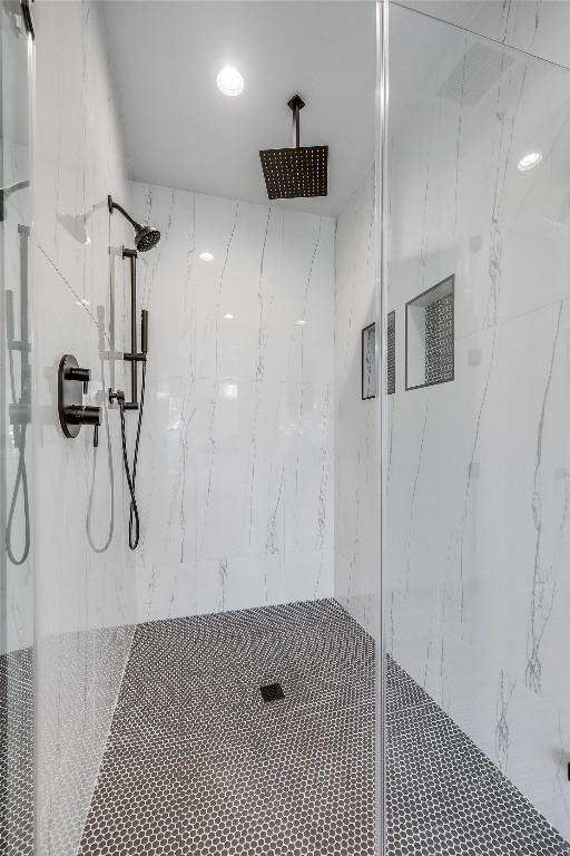 bathroom featuring a shower with door