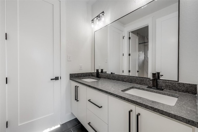 bathroom featuring tile patterned flooring and vanity