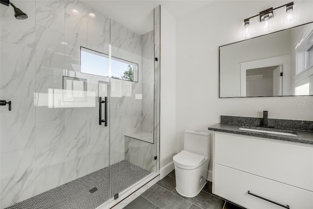 bathroom with tile patterned flooring, vanity, toilet, and a shower with shower door