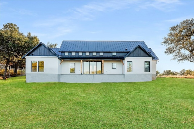 rear view of house featuring a lawn