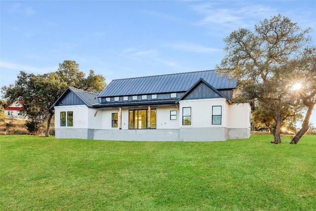 rear view of property featuring a yard