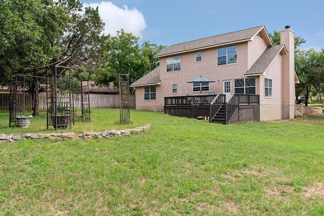 back of house featuring a yard and a deck