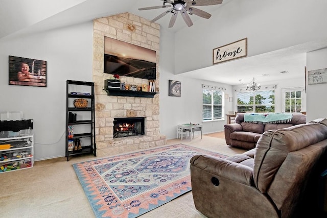 living room featuring vaulted ceiling, a fireplace, light colored carpet, and ceiling fan with notable chandelier