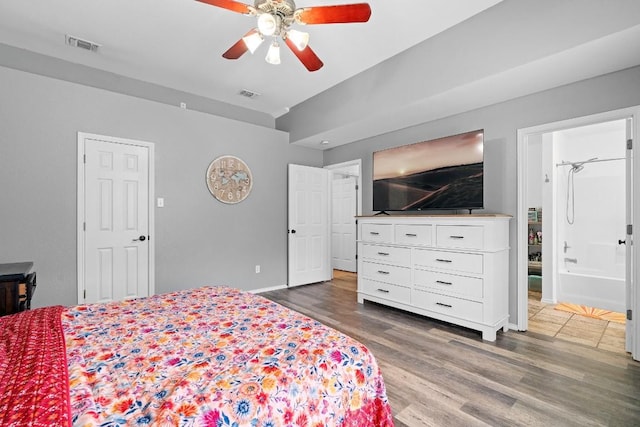 bedroom featuring ceiling fan, dark hardwood / wood-style flooring, and ensuite bathroom