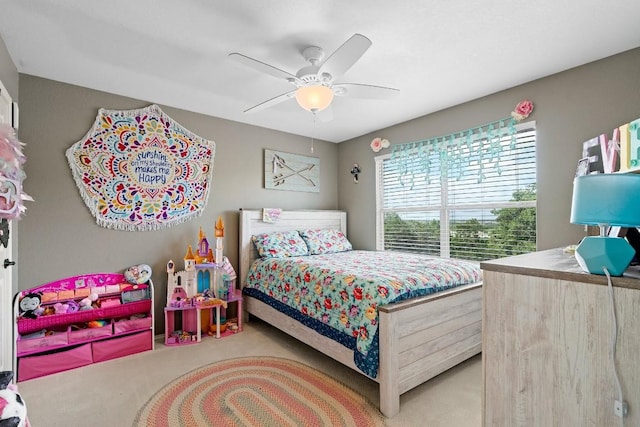 bedroom with ceiling fan and light carpet