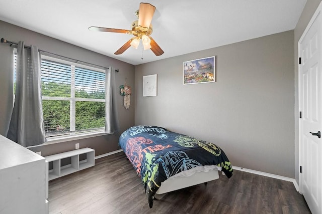 bedroom with ceiling fan and dark wood-type flooring