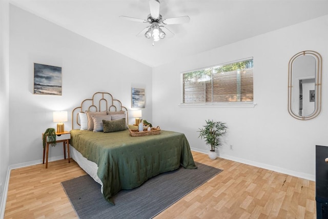 bedroom with hardwood / wood-style floors, vaulted ceiling, and ceiling fan