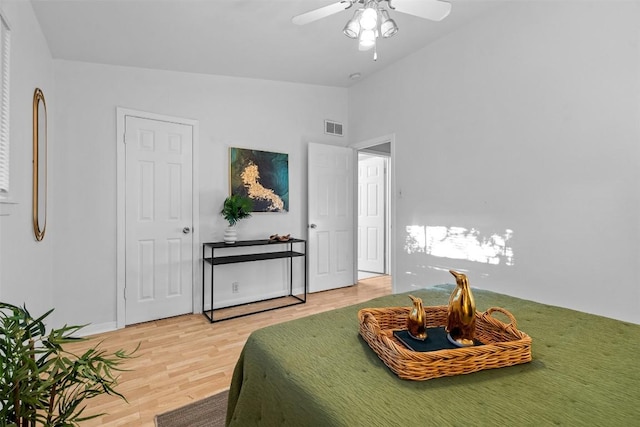 bedroom featuring wood-type flooring, vaulted ceiling, and ceiling fan