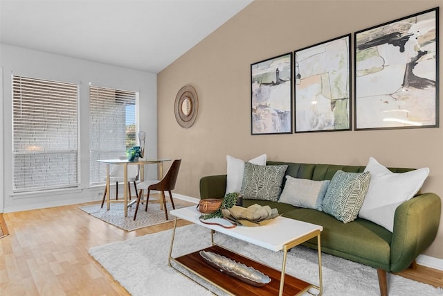 living room with hardwood / wood-style floors and vaulted ceiling