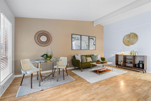 living room featuring lofted ceiling with beams and wood-type flooring