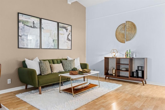 living room with beam ceiling and hardwood / wood-style flooring