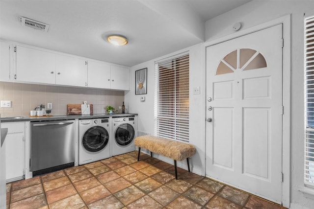 clothes washing area with separate washer and dryer