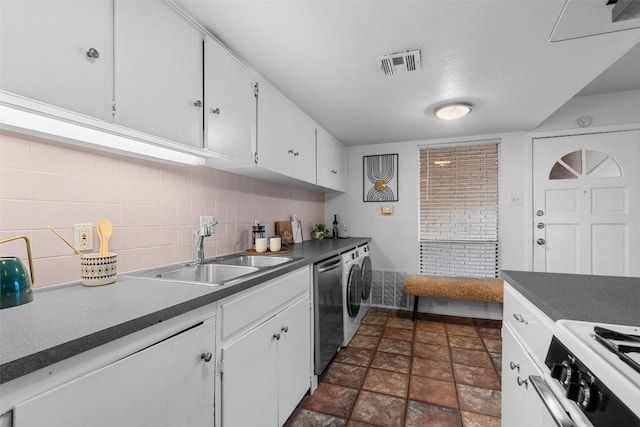 kitchen featuring decorative backsplash, white range oven, sink, washer and dryer, and white cabinetry