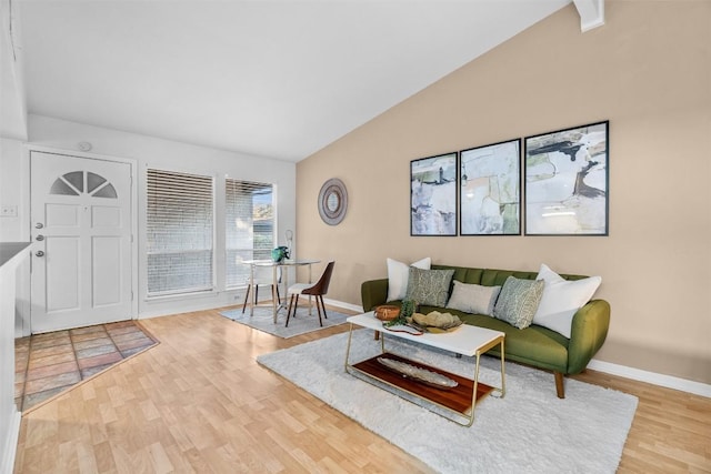 living room with vaulted ceiling and hardwood / wood-style flooring