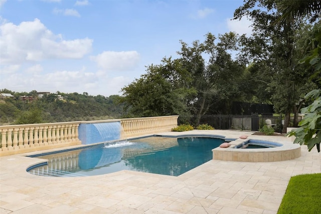 view of swimming pool featuring pool water feature, an in ground hot tub, and a patio