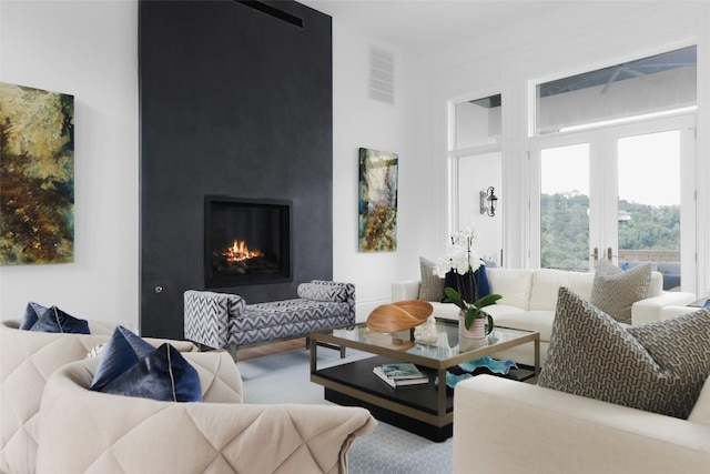 living room with a fireplace and french doors