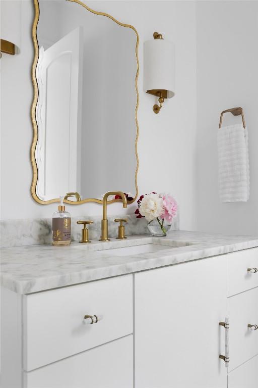 bathroom with water heater and vanity