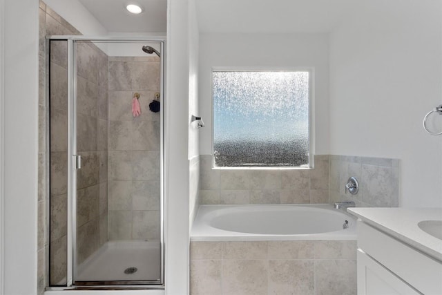 bathroom featuring vanity and separate shower and tub